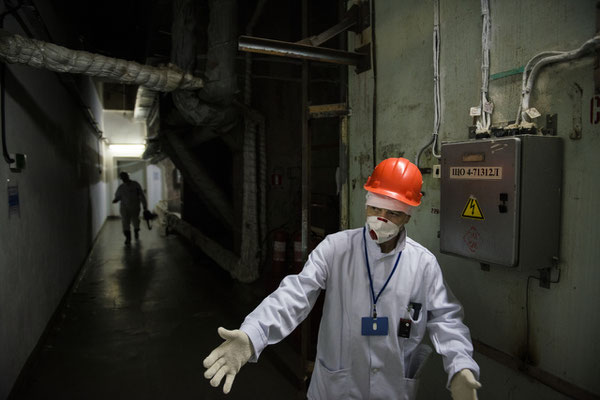 The manager of the guided tours in the Chernobyl nuclear power plant explains the security measures for workers inside control room number 4.