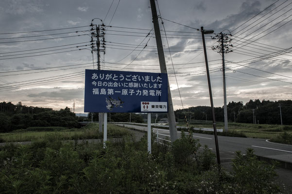 The roadsign put by Tepco at the exit of Fukushima Daiichi nuclear plant tells: "thank you for your visit, it was great to meet you, hope to see you soon.TOKYO DENRYOKU (TEPCO)". Fukushima No-Go Zone.