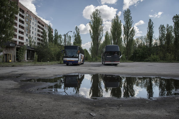 Buses parked in the main square of the ghost town of Pripyat waiting for the former inhabitants to visit their city.