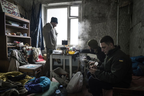 The stalkers Jimmy, Sasha and Maxim while preparing their breakfast in their apartment in the ghost town of Pripyat. Chernobyl Exclusion Zone. 