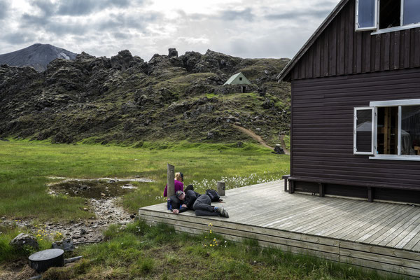 Iceland. Hikers at the Landmannalaugar base camp, a hiking centre open during the summer. Since 1951 it has also served as a mountain hostel and can host up to 78 people. The area is a popular tourist destination because of its geological formations