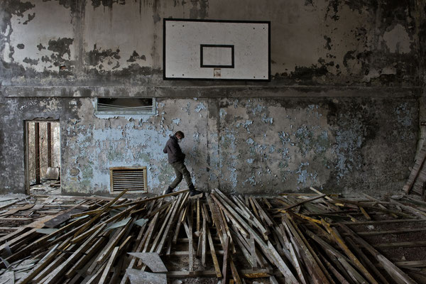 A tourist while exploring the swimming pool gym, Pripyat, exclusion zone