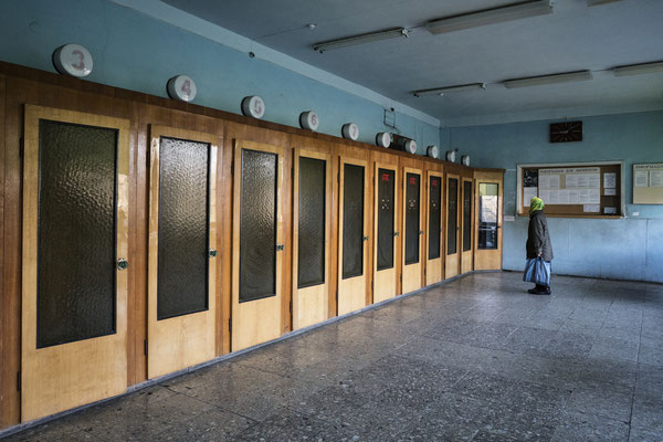 The post office in the town of Chernobyl in the exclusion zone. A line of telephone cabins from the Soviet era, no longer in use also due to the advent of mobile phones