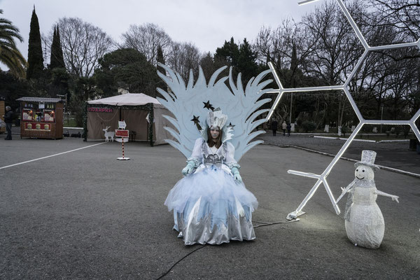 A local fair in Sukhumi. A girl dressed as a princess poses for pictures during the New Year celebrations.