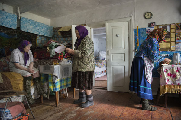 Hanna with her sisters Sophia and Maria in her home while she is preparing lunch. Kupovate, Chernobyl Exclusion Zone