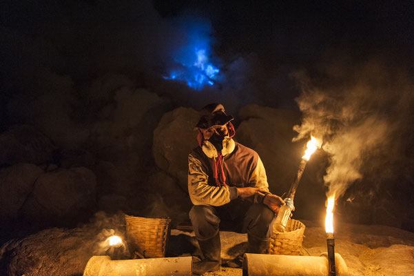 Sulphur miner while waiting to climb up the crater of the vulcano with his load during his night shift