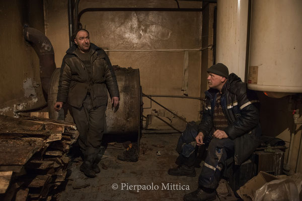 Alexander and Pavel while warming themselves close to the heating system