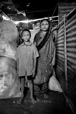 Abdul Jabbar 11 years old, with his boss. He is 6 years that is working as a tokai and he has a debt of 10000 thousands taka (100 Euros).