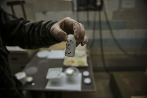 A lab technician shows an analyzed sample taken from the exclusion zone. Scientific laboratories of the city of Chernobyl.