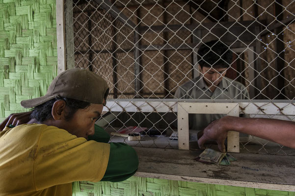 A sulhpur miners while receiving money for his load