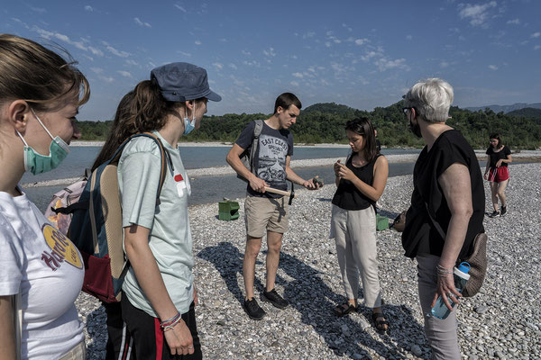The students of the first year classroom searching for stones on the River Tagliamento
