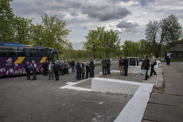 Former exclusion zone inhabitants in the main square of the city of Chernobyl as they wait to board the bus to exit the exclusion zone after their visit.