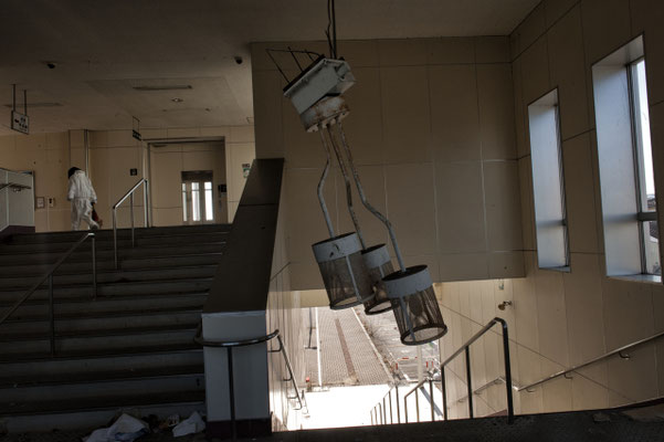 Abandoned train station with animal activist searching for abandoned pets, Okuma city, Fukushima "No-Go Zone", Japan. 
