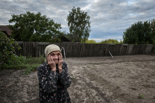 Maria Shovkuta, 89 years old, in the garden of her house, Opachici Village. Maria is showing her garden, where she used to grow vegetables for her needs, but now she is becoming older and for her is becoming very difficult to grow vegetable.