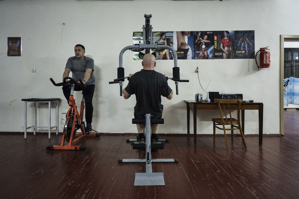 Two men train at the gym in Chernobyl. Many come here after work in order to stay in shape.