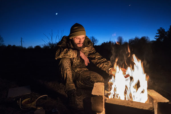 Jimmy preapring dinner and warming himself, in the abandoned village of Rudnya Veresnya before heading to Pripyat