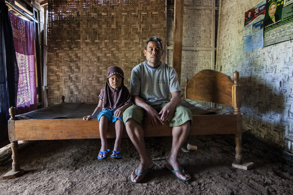  Usni with his grand daughter at home, he lives in Sumberwatu village