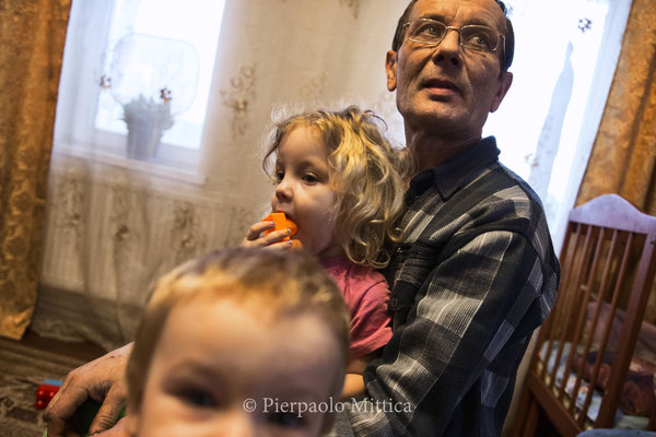 Victor with his family at home in Kovalinka