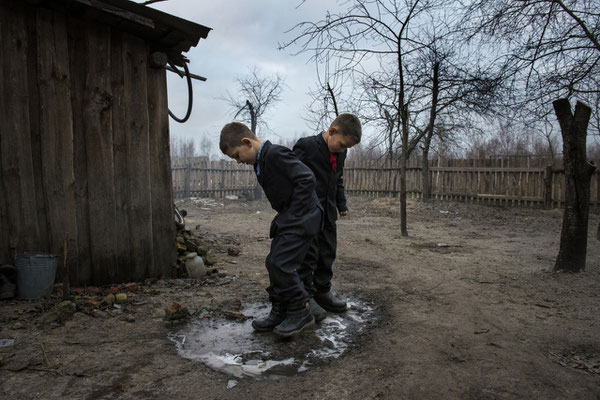 Vladik and Igor in the garden of their house, waiting to go to school. Vladik, 7 years old and Igor, 6 years old, live in Radinka, one of the most contaminated village around the Chernobyl Exclusion Zone.