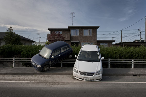 abandoned cars parked by the tsunami, Odaka city, Fukushima "No-Go Zone", Japan.