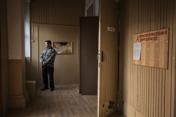 The house of culture in Chernobyl town. An audience member waits for the beginning of a theatre show