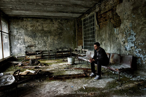 Alexey is practicing to become a Chernobyl tourist guide, here he is in the lobby of Pripyat hospital waiting for the tourists, Pripyat, exclusion zone