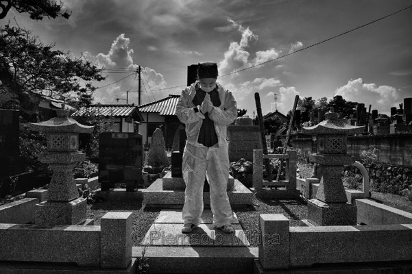 Mister Matsumoto, Yakuza member and Tepco contractor is praying on his family grave, Fukushima "No-Go Zone", Japan.