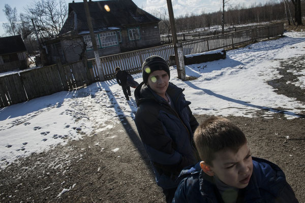 Igor, Vladik and Viktor in front of their home in Radinka waiting to go to the hospital in Ivankiv for analysis