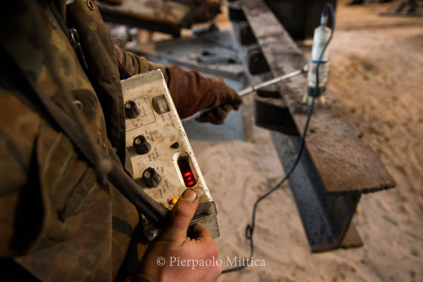 Yuriy while measuring the contamination level of the scrap metal before the sandblasting. Before the sandblasting this scrap metal coming from a local railroad track has a level of contamination of more than 900 bpm (normal level 20 bpm)