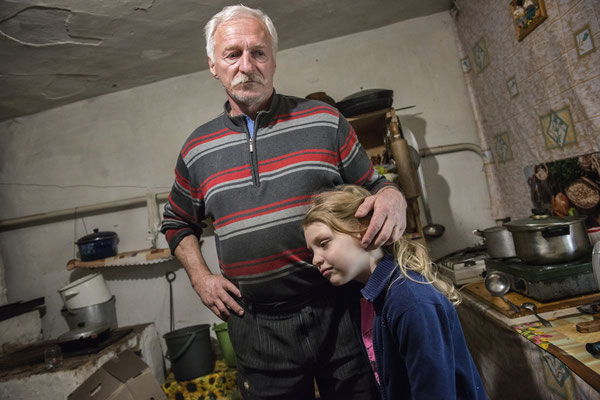Dimitri 60 years with his nephew Vlada 7 years, in his home in the village of Marianovka. Vlada lives in Kiev but sometimes her grandfather Dimitri brings her illegally in his house inside the zone to stay with him some days. Chernobyl Exclusion Zone.