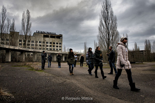 Tourists with their guide in the main square of Pripyat, exclusion zone