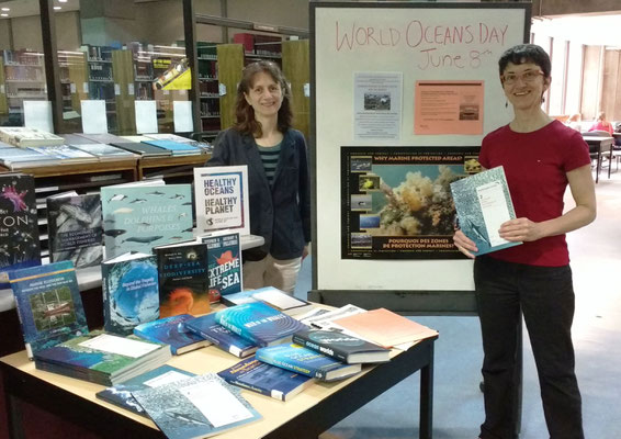 IOI CANADA:  Book display - Librarian Michelle Paon holding a copy of one of the World Ocean Reviews, together with the IOI Programme Officer, Madeleine Coffen-Smout  