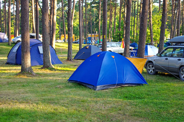 Camping and tents on the grass in the summer by nulinukas