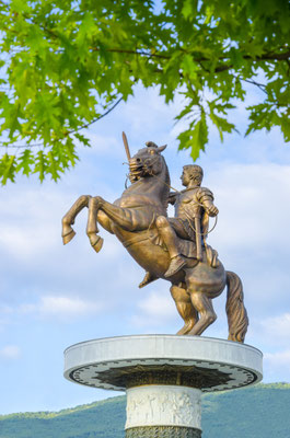 Amazing view of Statue of Alexander the Great through the tree branches in downtown of Skopje, Macedonia, portrait Copyright zefart