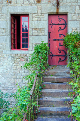 Red medieval door in Mont Saint Michel abbey in France -Copyright Max Topchii