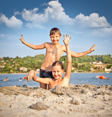 Boy and Girl on the public beach Strand at Danube river in Novi Sad, Serbia. Copyright Aleksandar Todorovic