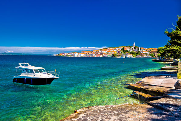 Kali beach and boat on turquoise sea, Island of Ugljan, Croatia - Copyright xbrchx