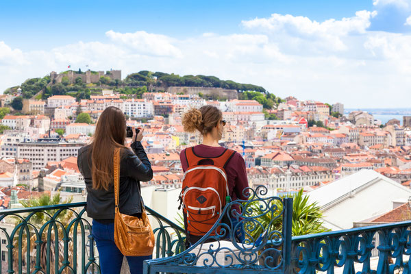 Tourist watching to Lisbon rooftop from Sao Pedro de Alcantara viewpoint - Miradouro in Portugal Copyright Samuel Borges Photography