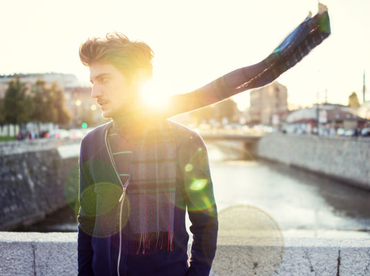 Young man on Sarajevo sunset feeling wind in his scarf as double exposure lens flare Copyright Zurijeta