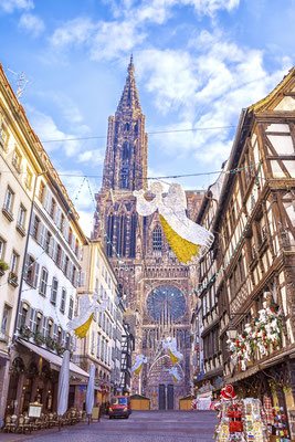 Festive Christmas decorations on streets in medieval city of Strasbourg, France - By MarinaDa