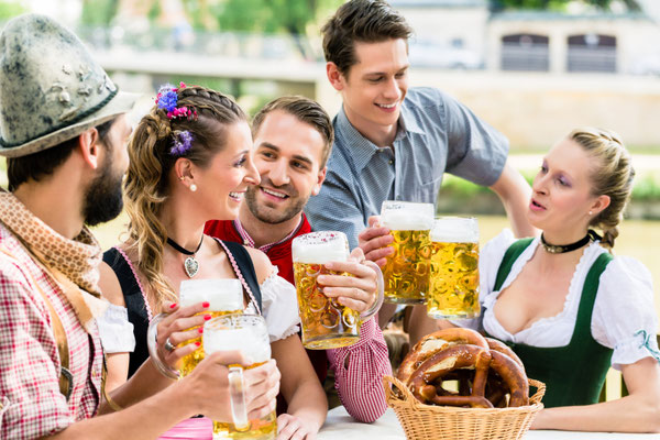 Friends in Bavarian beer garden drinking in summer Copyright Kzenon