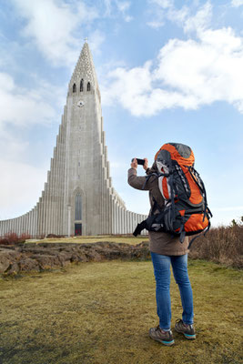 rear view of backpacker tourist travel woman taking pictures of the Hallgrimskirkja cathedral in reykjavik iceland Copyright Daxiao Productions - European Best Destinations 