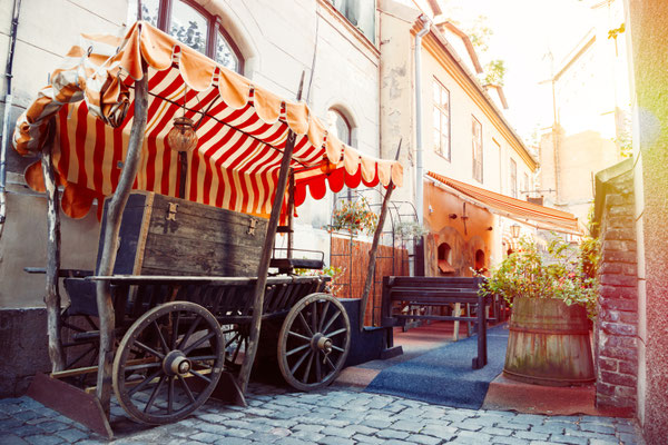 Medieval street and fragment of outdoors cafe in the old city of Riga, Latvia Copyright Chamille White