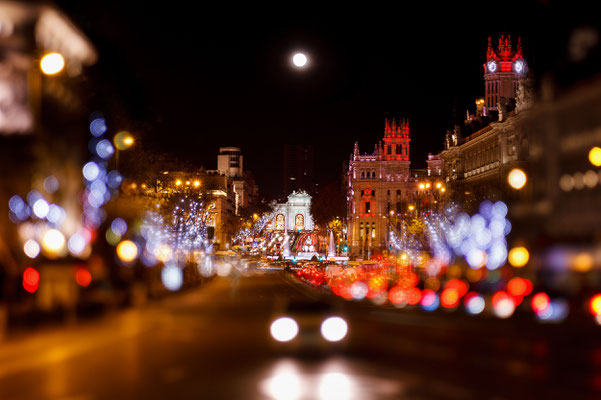 Madrid at Christmas. Rays of traffic lights on Cibeles square, Cibeles fountain in front of the The City Hall or the former Palace of Communications in Madrid, Spain. Copyright Nacroba