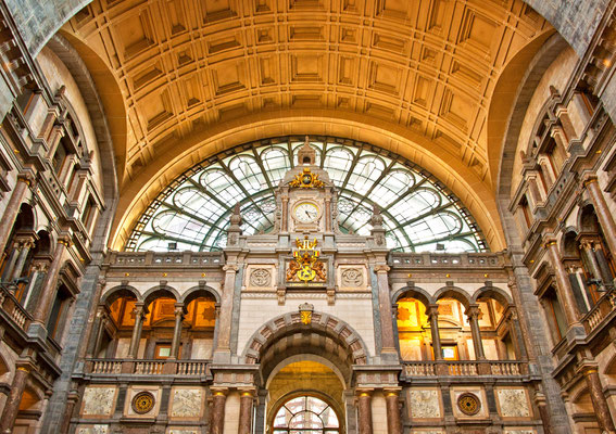 Famous old clock on the facade of the old beautiful railway station in Antwerp. Belgium. Copyright Botond Horvath