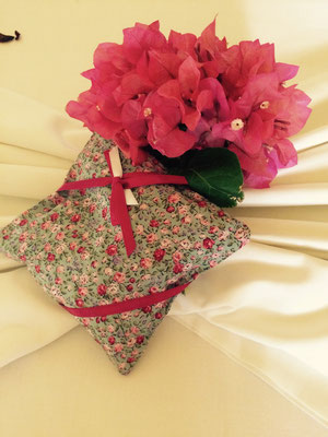 lavender pillow with bougainville on a wedding bed