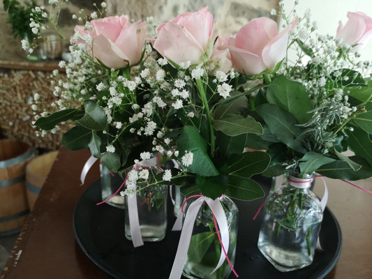 pink roses in glass vases for a table decoration in a wedding