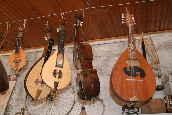 tradtional Greek musical instruments hanging on a wall