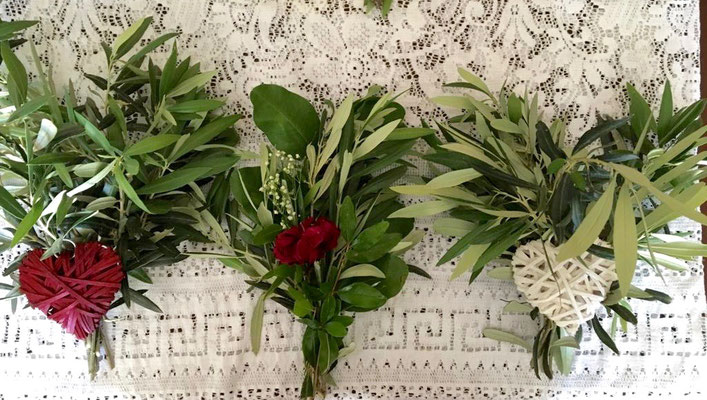 olive branches  with roses on a white embroidered table cover