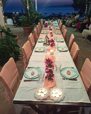festlich dekorierte Hochzeitstafel mit rosa Hussen und Teelichtern